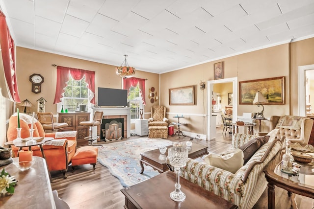 living room with light wood-type flooring and ornamental molding