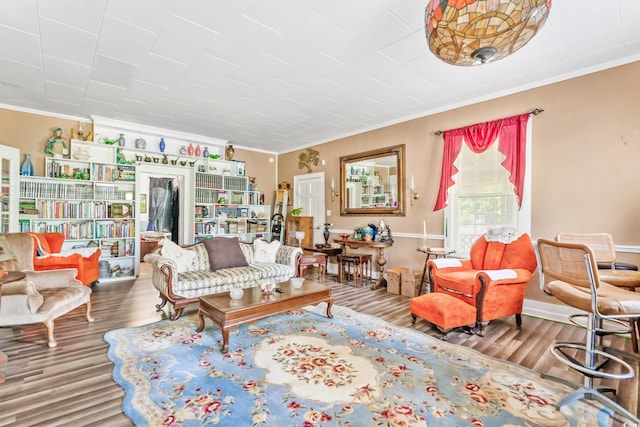 living room with wood-type flooring and crown molding