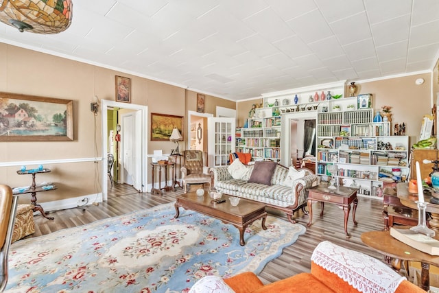 living room with hardwood / wood-style floors and crown molding