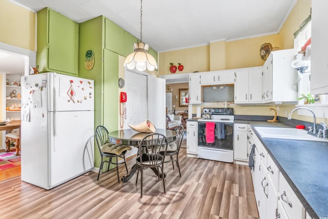 kitchen featuring white cabinetry, sink, hanging light fixtures, light hardwood / wood-style floors, and white appliances