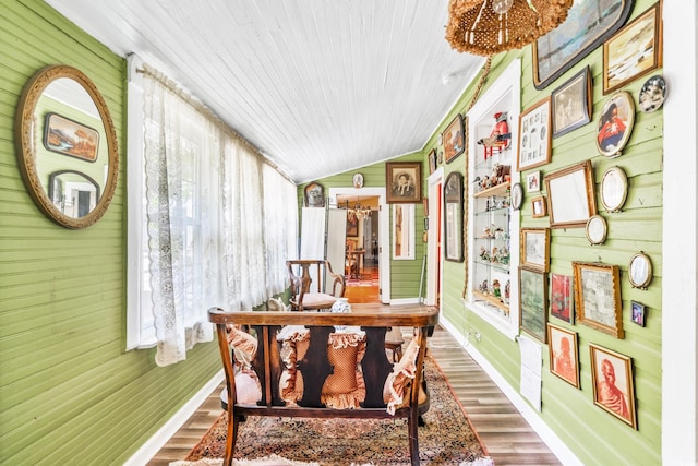 sunroom featuring vaulted ceiling and wood ceiling