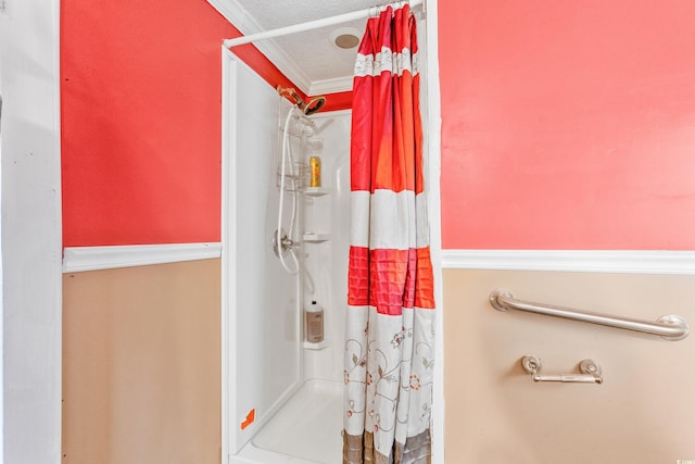 bathroom with a shower with curtain, a textured ceiling, and ornamental molding