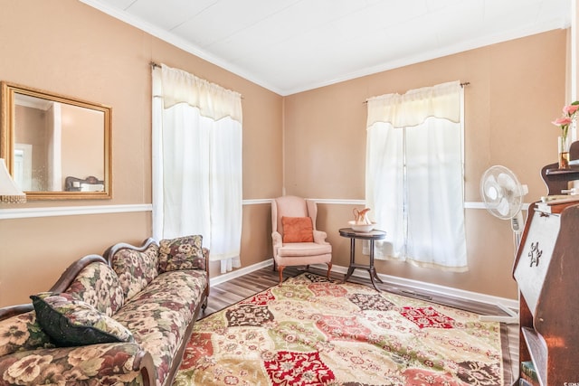 sitting room with hardwood / wood-style flooring and crown molding