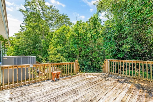 wooden deck featuring central AC unit