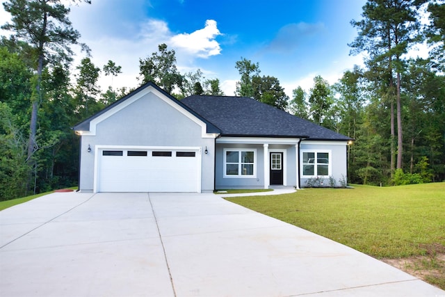 view of front of property with a garage and a front lawn