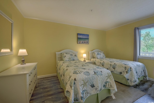 bedroom featuring baseboards, ornamental molding, and dark wood-type flooring