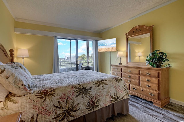 bedroom featuring ornamental molding and a textured ceiling