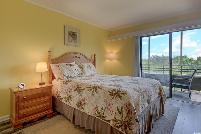 bedroom with access to exterior, crown molding, and wood finished floors