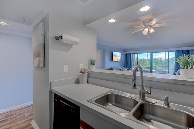 kitchen with recessed lighting, a sink, light wood-style floors, baseboards, and dishwasher