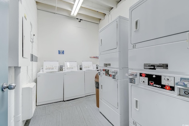 common laundry area featuring stacked washer / drying machine and separate washer and dryer