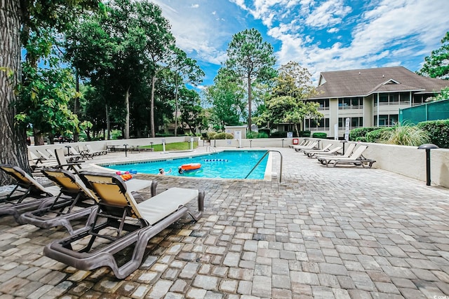 pool featuring a patio area and fence