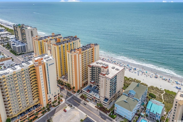 drone / aerial view featuring a water view and a beach view