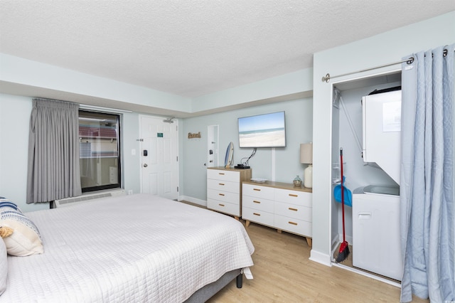 bedroom featuring refrigerator, light hardwood / wood-style flooring, and a textured ceiling