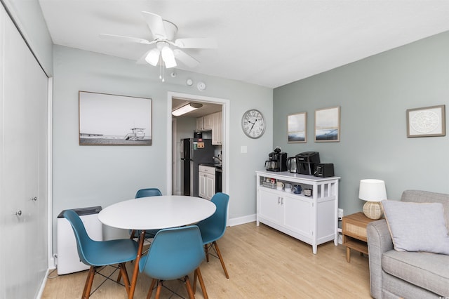 dining area with ceiling fan and light wood-type flooring