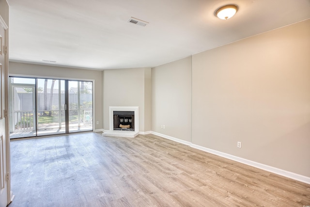 unfurnished living room with light hardwood / wood-style floors