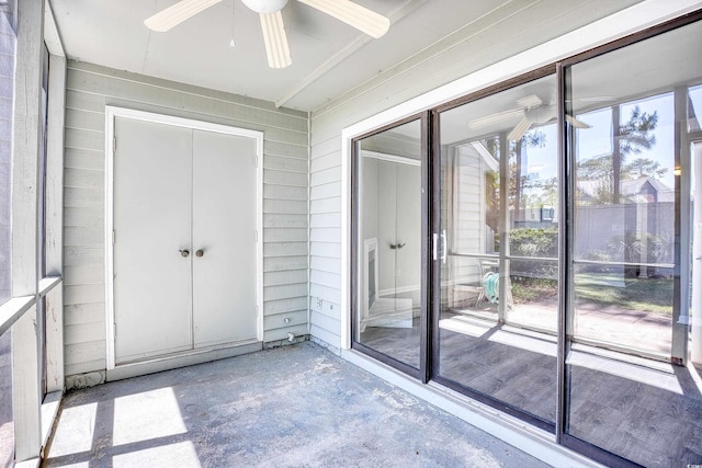 unfurnished sunroom featuring ceiling fan