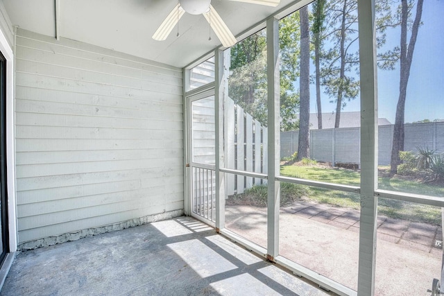 unfurnished sunroom featuring ceiling fan