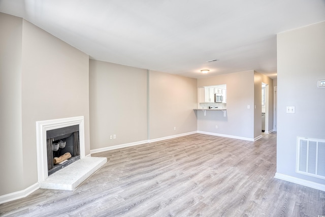 unfurnished living room featuring light wood-type flooring