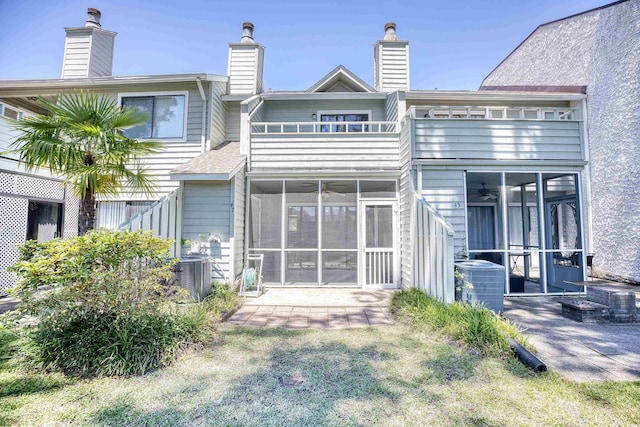 back of house with central AC and a sunroom