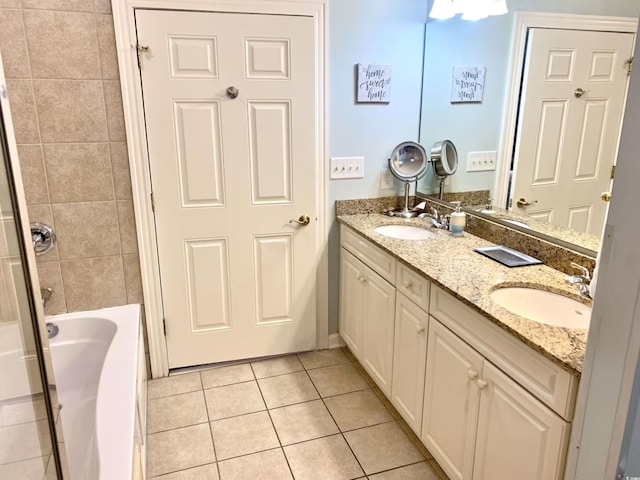 bathroom featuring tile patterned floors, vanity, and tiled shower / bath combo