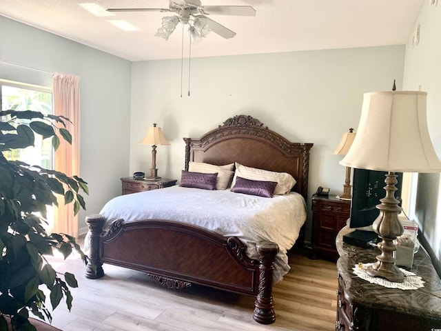 bedroom with light hardwood / wood-style flooring and ceiling fan