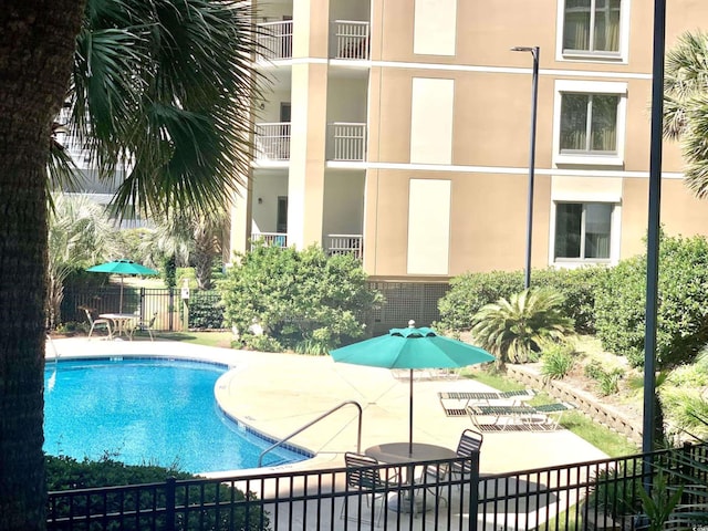 view of swimming pool featuring a patio area