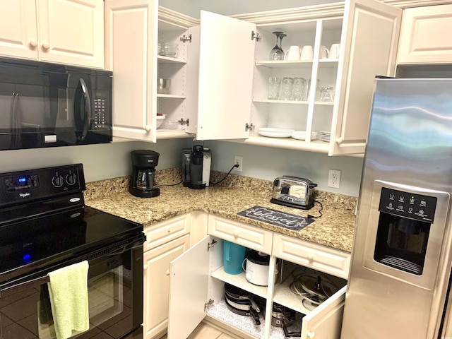 kitchen featuring white cabinetry, light stone countertops, and black appliances