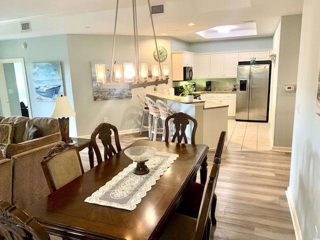 dining area featuring light wood-type flooring