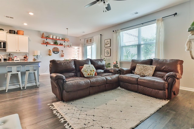 living room featuring dark hardwood / wood-style flooring and ceiling fan