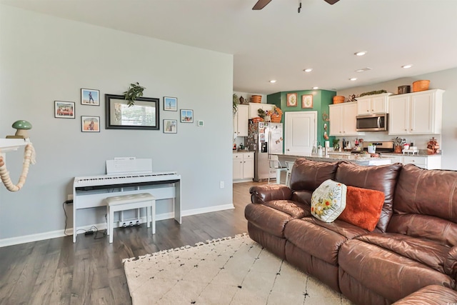 living room with ceiling fan and dark hardwood / wood-style floors