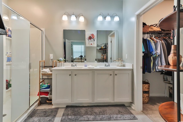 bathroom with vanity and a shower with shower door