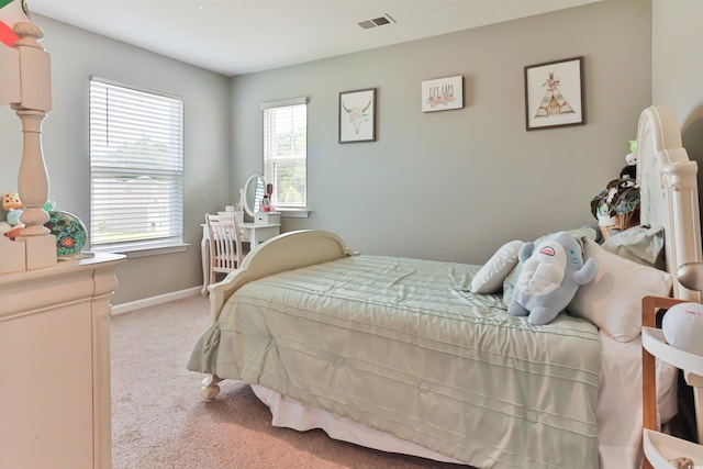 bedroom featuring light carpet