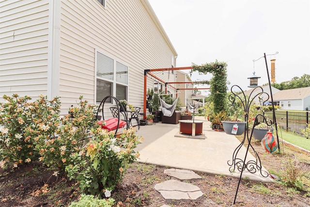 view of patio with a fire pit and a pergola