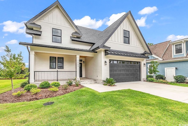 view of front of home with a front lawn, a garage, and a porch