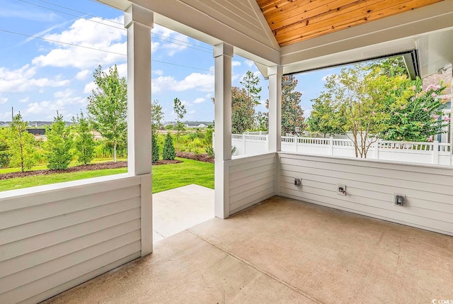 unfurnished sunroom featuring a wealth of natural light and vaulted ceiling