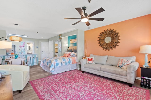 bedroom with ceiling fan and light hardwood / wood-style flooring