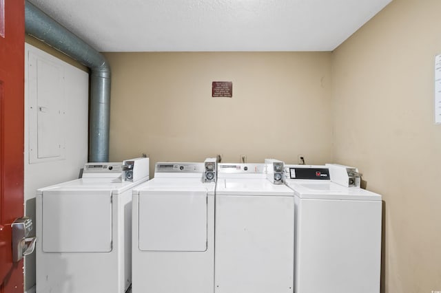 washroom featuring separate washer and dryer and a textured ceiling