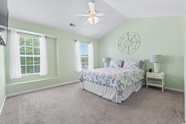 bedroom featuring ceiling fan, multiple windows, vaulted ceiling, and carpet