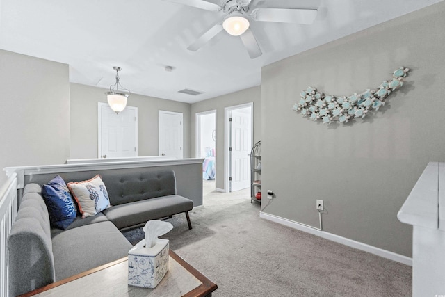 carpeted living room with ceiling fan