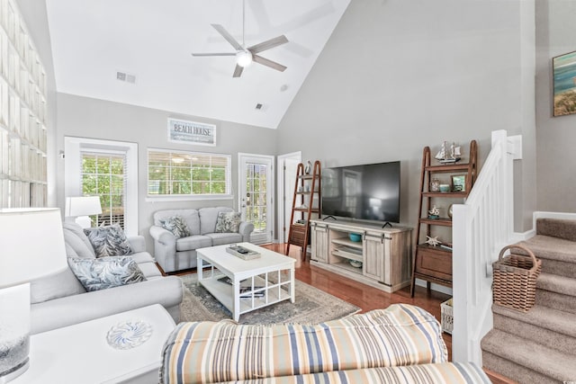 living room with hardwood / wood-style floors, a wealth of natural light, high vaulted ceiling, and ceiling fan