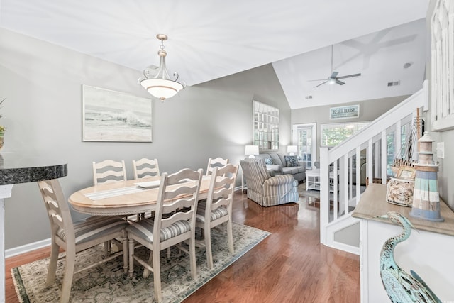 dining space featuring dark wood-type flooring, ceiling fan, and lofted ceiling