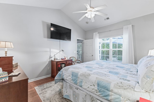 bedroom with ceiling fan, lofted ceiling, and wood-type flooring