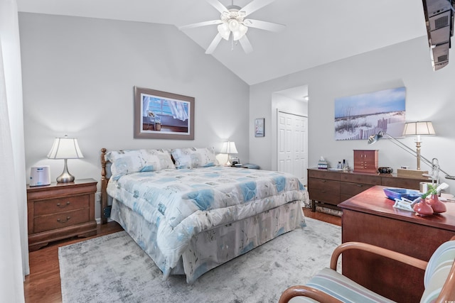 bedroom with lofted ceiling, hardwood / wood-style floors, a closet, and ceiling fan