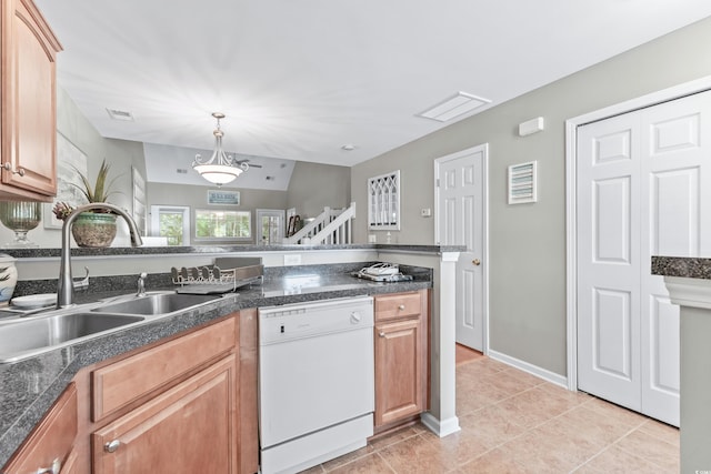 kitchen featuring white dishwasher, sink, light tile patterned floors, and hanging light fixtures