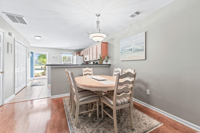 dining area with light hardwood / wood-style floors