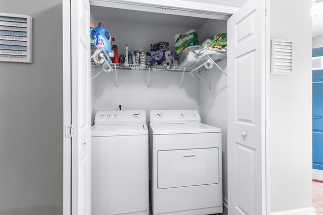 washroom featuring washer and dryer