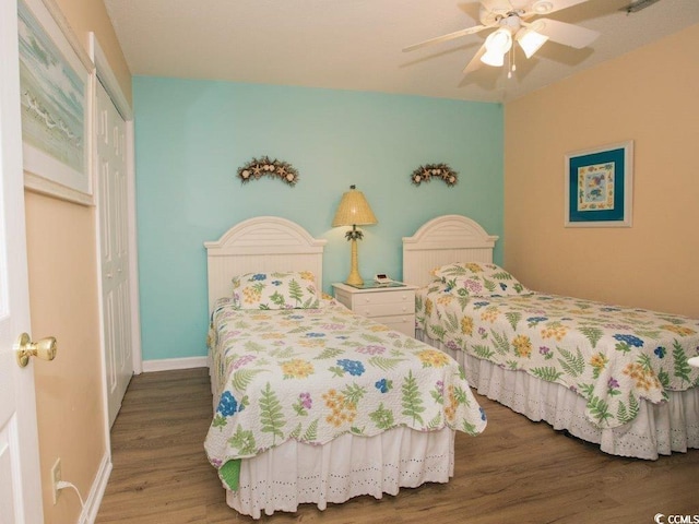 bedroom featuring ceiling fan, a closet, and hardwood / wood-style flooring