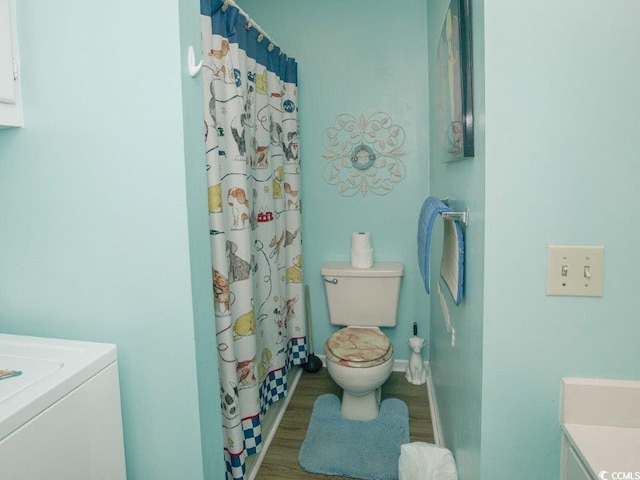 bathroom with wood-type flooring, vanity, washer / clothes dryer, and toilet