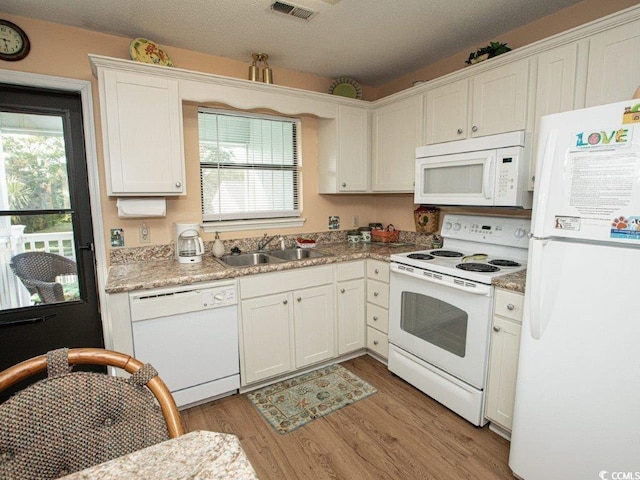 kitchen featuring white appliances, light hardwood / wood-style flooring, white cabinetry, and sink