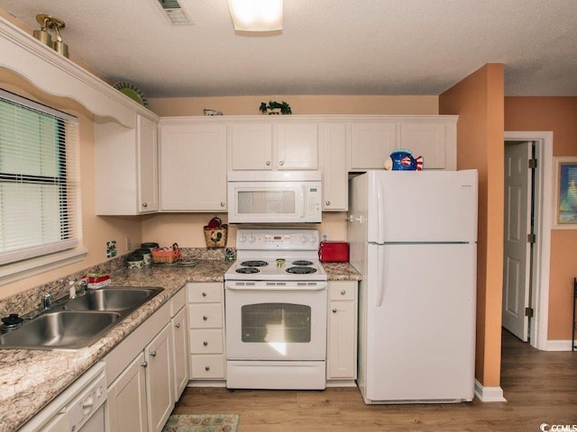 kitchen featuring white cabinets, light hardwood / wood-style floors, white appliances, and sink